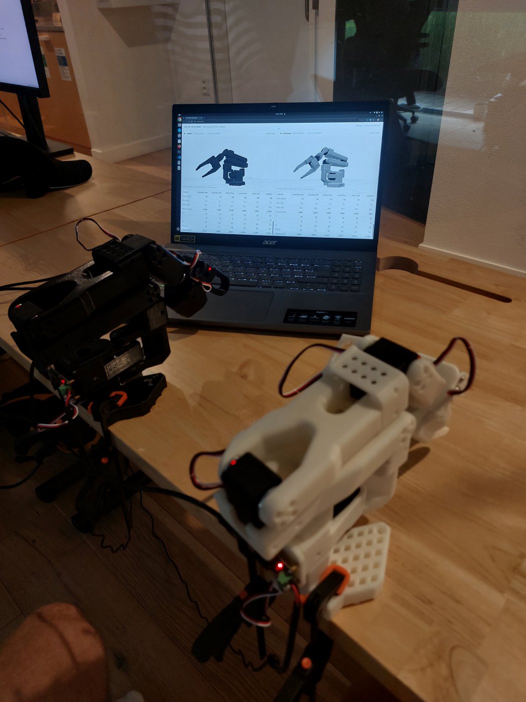 Both finished arms standing next to the laptop